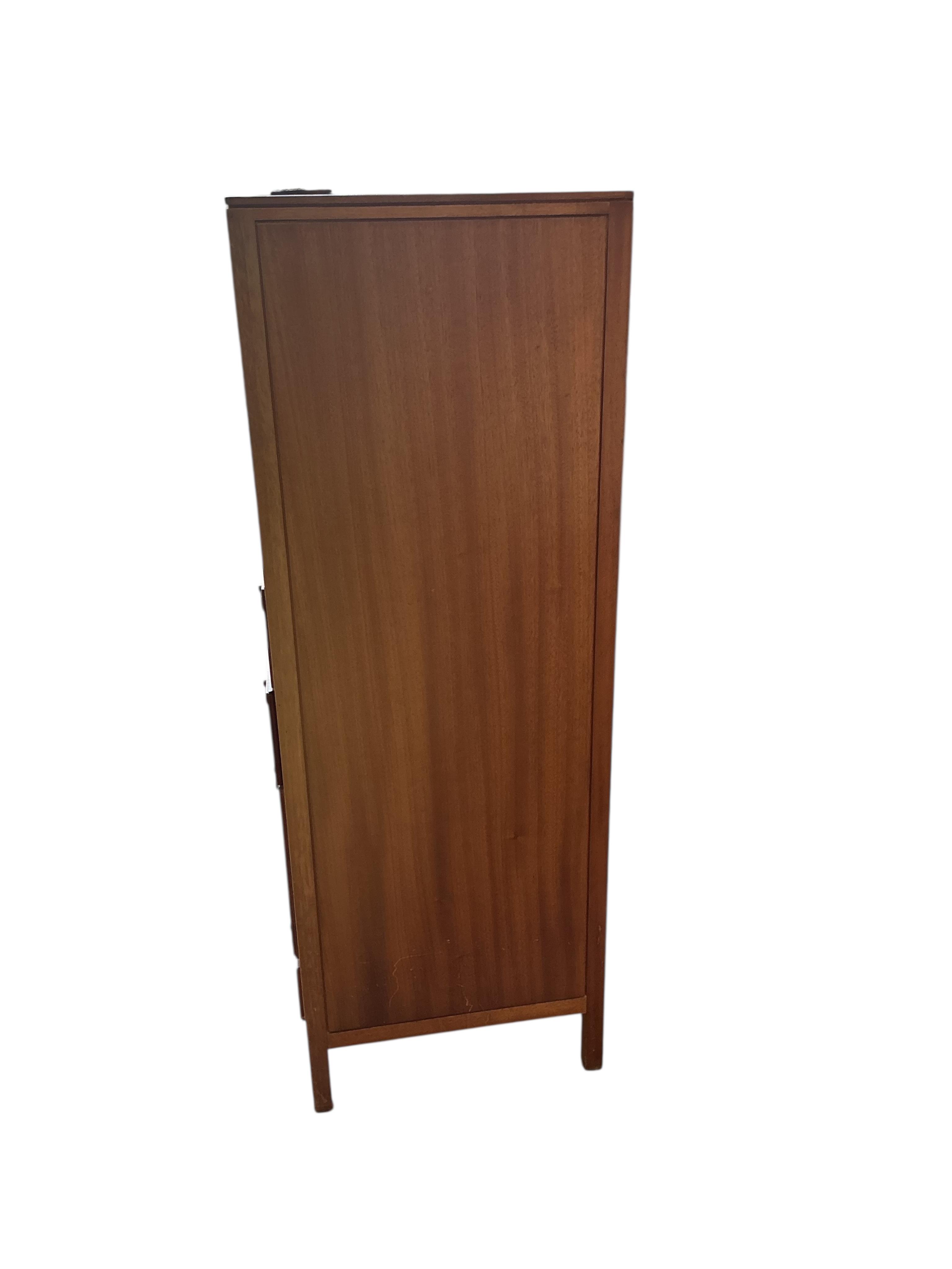 A Loughborough For Heals brass inlaid teak four piece bedroom suite comprising: triple wardrobe, width 120cm, depth 54cm, height 176cm, two chests of drawers and a toilet mirror